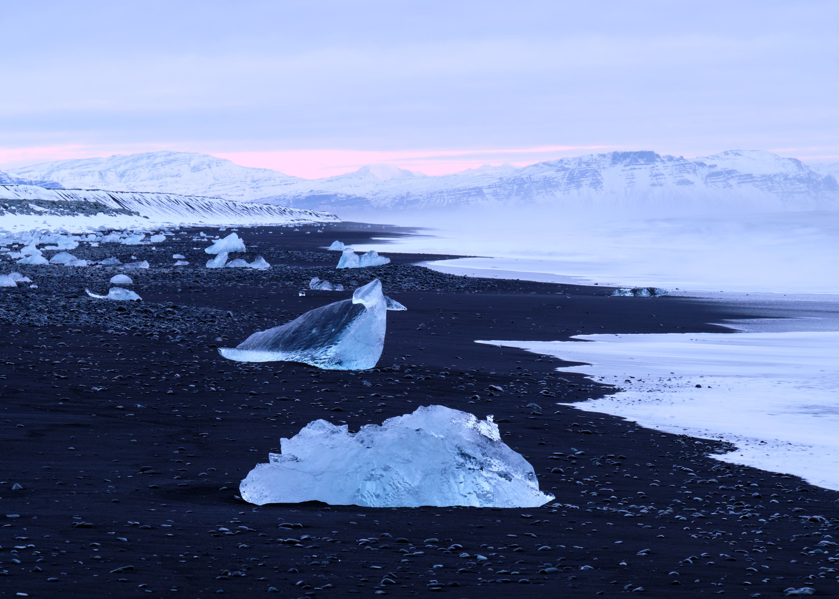 Ice chunks on Diamond Beach at pink dusk