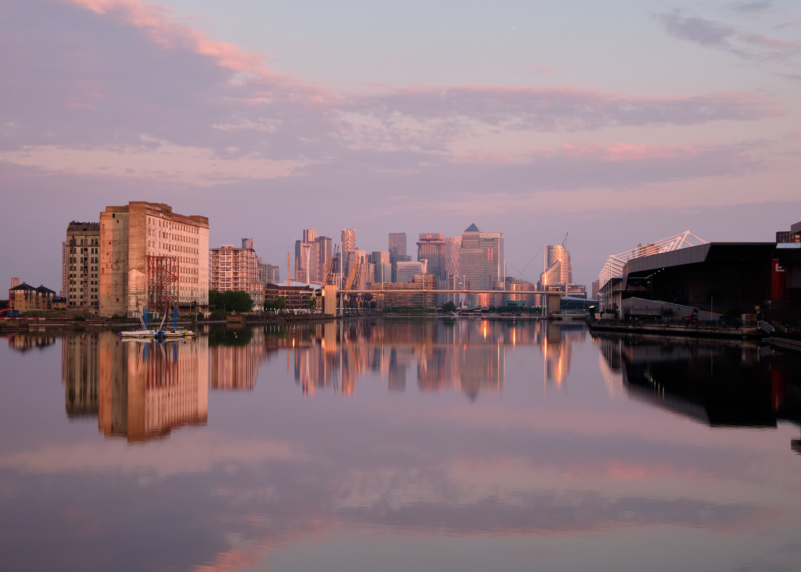 Canary Wharf reflected in mirror-calm Royal Victoria Dock